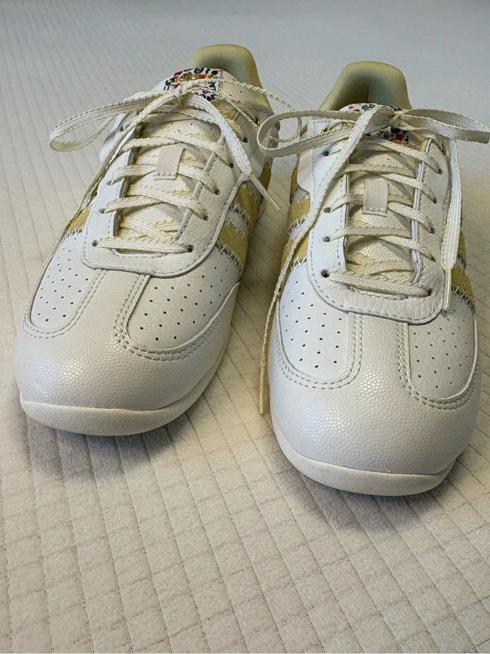 Adidas cream colored sneakers with floral accents